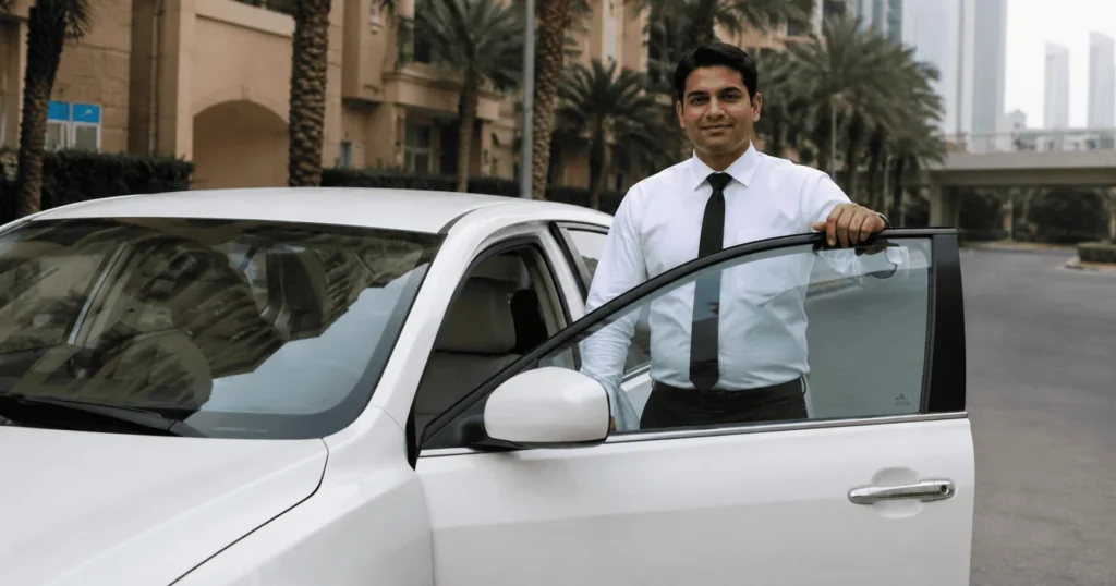 Light Vehicle Driver Job in Dubai – Professional driver standing beside a company vehicle before transporting premium vehicles in the UAE.